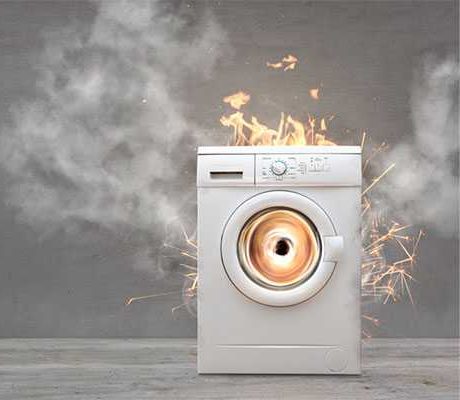 What causes the smell of burning rubber from the Absal washing machine?